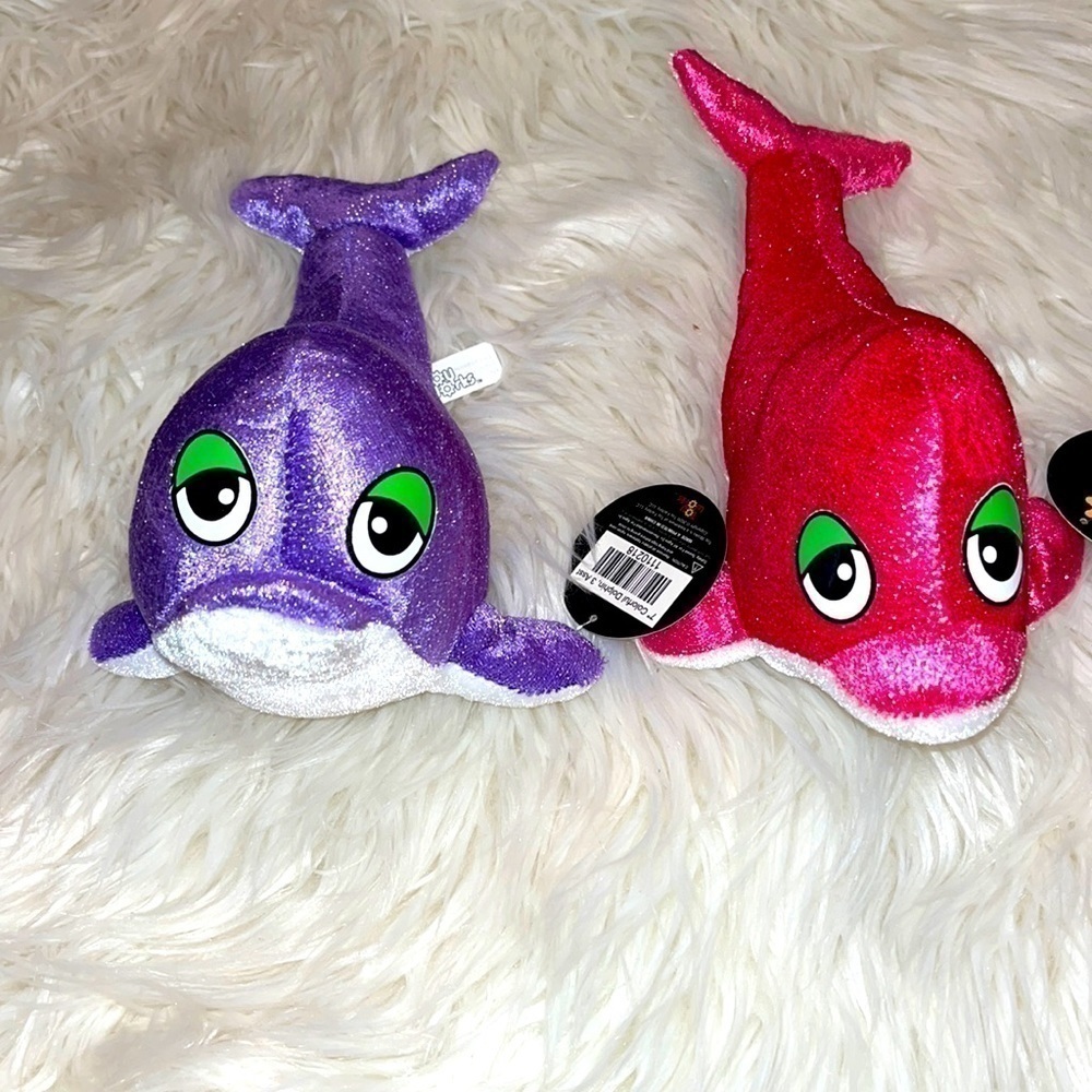 Set of 2 plush dolphins. NWT. 9” long. Pink purple. Fast shipping.